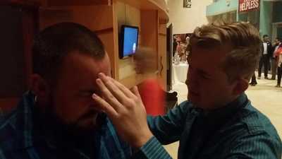 Zach praying with a man